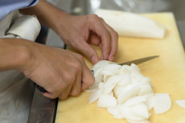 Chef cutting radish prepare food in restaurant,Hand cutting vegetable fast it's skill