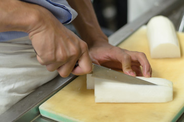 Chef cutting radish prepare food in restaurant,Hand cutting vegetable fast it's skill