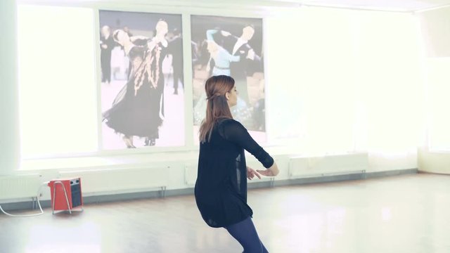 Graceful girl practicing ballet in dance studio in 4K