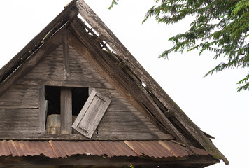 Fototapeta na wymiar closed windows on rural wooden house, old broken wood window