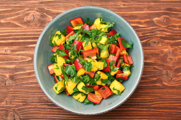 Mango salad with pepper and parsley in a bowl