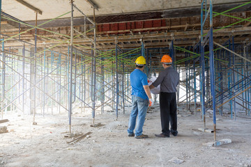 Construction concepts, Engineer and Architect working at Construction Site with blueprint