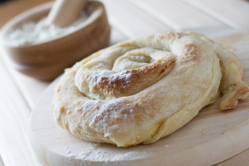 Freshly baked spiral cheese pie on the wooden plate