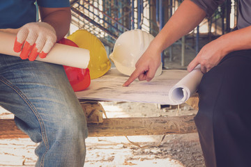Construction concepts, Engineer and Architect working at Construction Site with blueprint, Vintage Effect