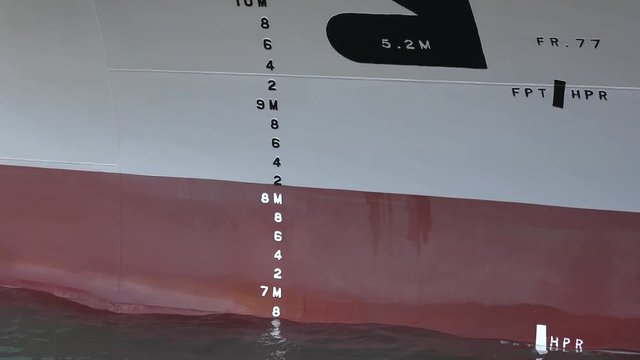 Waterline. A bulbous bow of a cargo ship in the ocean. The bulb modifies the way the water flows around the hull, reducing drag and thus increasing speed, range, fuel efficiency, and stability. 4K