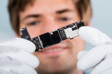 Man Holding Smart Phone Circuit Board