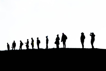 Naklejka na ściany i meble silhouette group of hiking on mountain with white background, subject is blurred