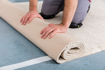 Worker's Hands Rolling Carpet