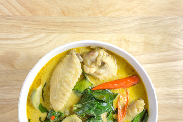 green curry chicken on wood table. Thai cuisine