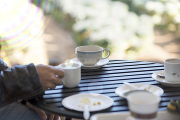 cup of coffee in hand, blank text and blur