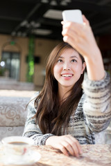 young pretty woman sits in cafe