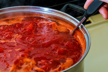 Ukrainian borsch cooking vegetable soup on the wood