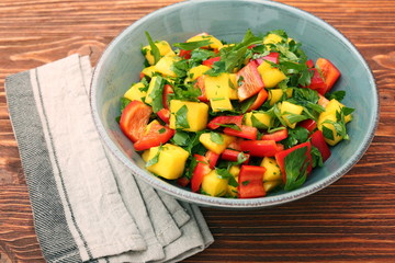Mango salad with pepper and parsley in a bowl