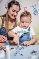 Fototapeta premium mother with kid paint and drawing
