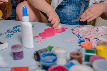 smilling boy making bunny for easter