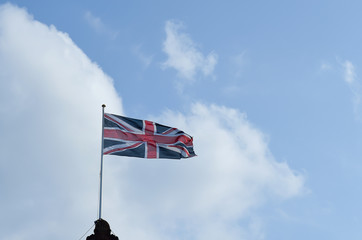 Flag of United Kingdom is Flying in sky.