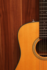 Obraz premium Acoustic guitar on a wooden background.