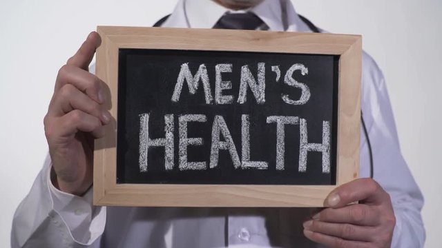 Mens health written on blackboard in urology doctor hands, reproductive medicine