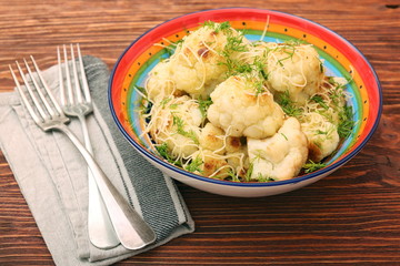 Fried cauliflower with cheese and greens