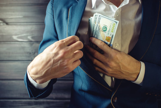 Businessman, member or officer puts a bribe in his pocket