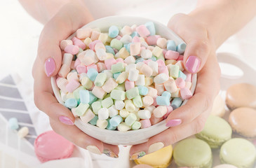 Womans hands with marshmallows