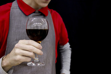 Wine glass with coffee in hand man in apron