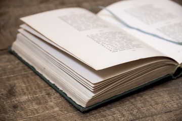 Vintage open book on  wooden table close-up