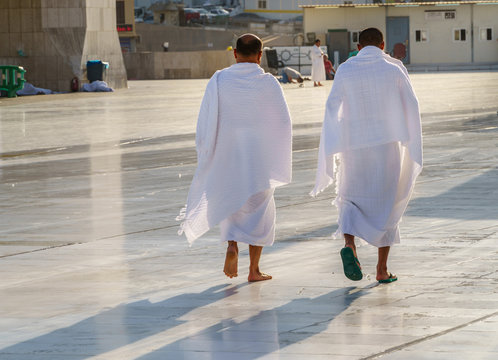 Mans muslim pilgrim in white traditional clothes.