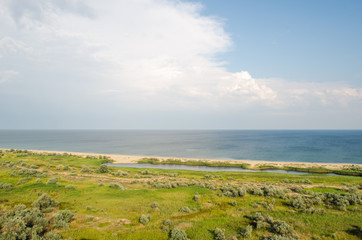 Fototapeta na wymiar summer landscape, the sand on the beach, blue sea with waves. of bird flight view