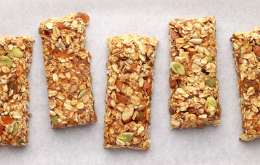 Homemade granola bars on white baking paper. - 139190044