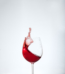 Bordeaux wine in the glass on a white background. The concept of alcohol and party.