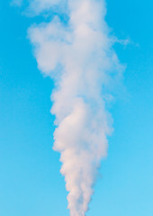 Fototapeta na wymiar white industrial smoke from the chimney on a blue sky