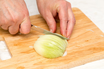 Obraz na płótnie Canvas Cook chopped onion on the board
