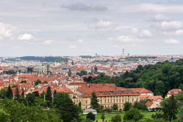 Fototapeta na wymiar Top view to old town, historical districts and red roofs of Prague, Czech republic from an observation deck on Petrin hill.
