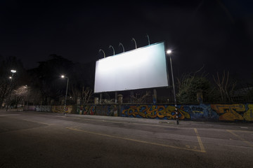 Blank billboard at night time. - obrazy, fototapety, plakaty