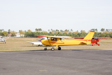 Private aircraft yellow and red just landed