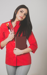 sexy pretty brunette woman with brush set and notebook