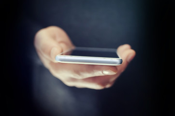 Angled view of modern phone in man hand 