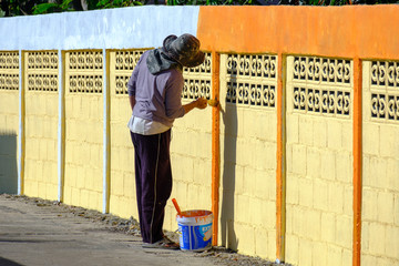 Workers paint the fence