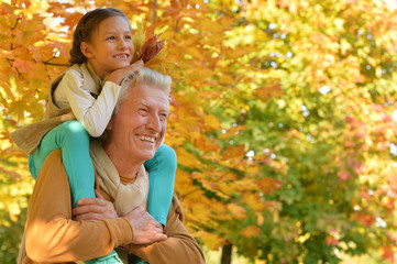 portrait of happy grandfather and granddaughter 