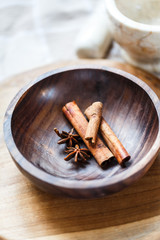 Spices in wooden bowl: star anise and cinnamon
