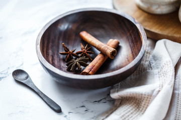 Spices in wooden bowl: star anise and cinnamon