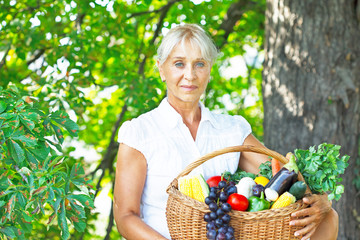 Young woman holding grocery shopping bag with vegetables