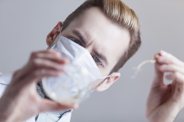 biologist with plants in Petri dish