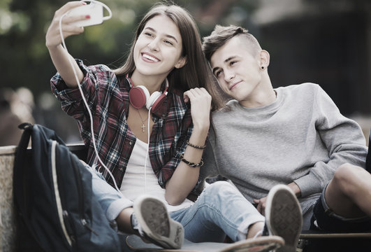 Teenagers taking selfie with smartphone