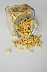 Pine nuts scattered from the jar