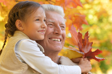 portrait of happy grandfather and granddaughter 