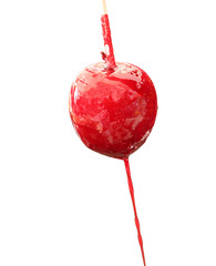 red apple with caramelized sugar syrup on white