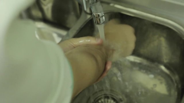 Doctor washes hands, close-up of man washes hands with soap, safety.