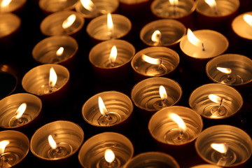 candles lit with the warm flame during the religious ceremony